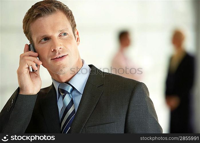 Businessman in Office Using Cell Phone