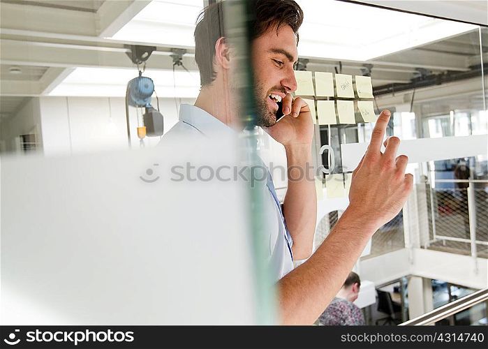 Businessman in office using mobile phone