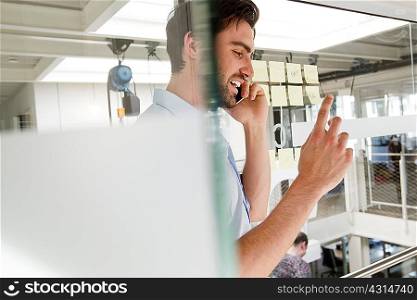 Businessman in office using mobile phone