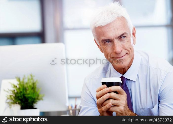 Businessman in office with a cup. Time for coffee