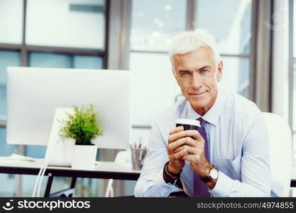 Businessman in office with a cup. Time for coffee