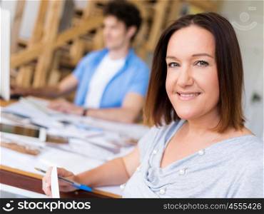 Businessman in office with her collegue at background