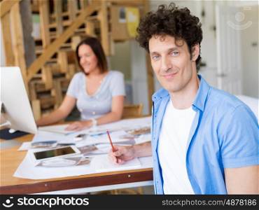 Businessman in office with his collegue at background