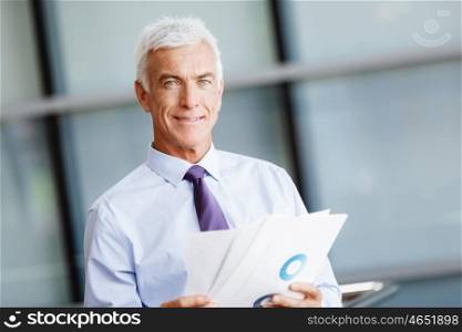 Businessman in office working with papers. New plans and new decisions