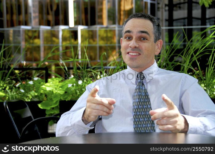 Businessman in outdoor cafe explaining an idea