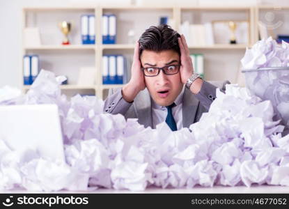 Businessman in paper recycling concept in office