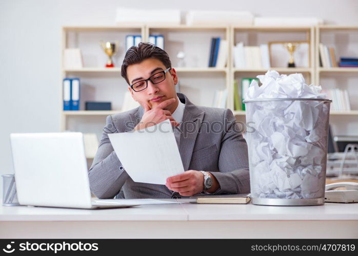 Businessman in paper recycling concept in office