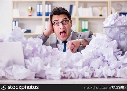 Businessman in paper recycling concept in office