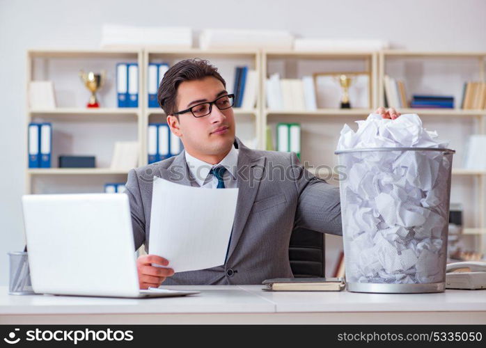 Businessman in paper recycling concept in office