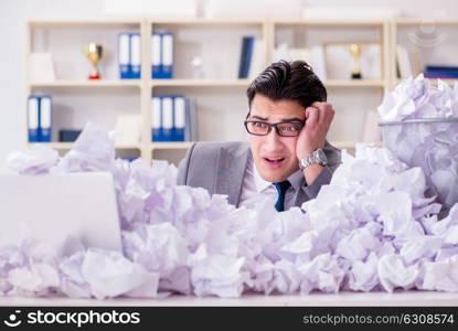 Businessman in paper recycling concept in office