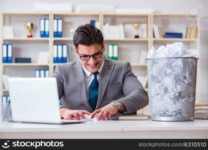 Businessman in paper recycling concept in office