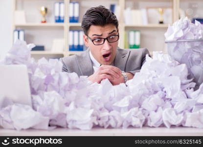 Businessman in paper recycling concept in office