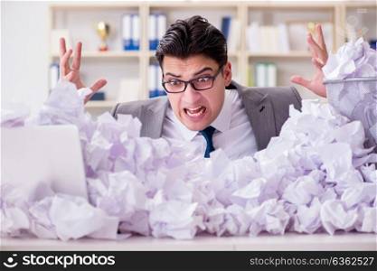 Businessman in paper recycling concept in office. The businessman in paper recycling concept in office