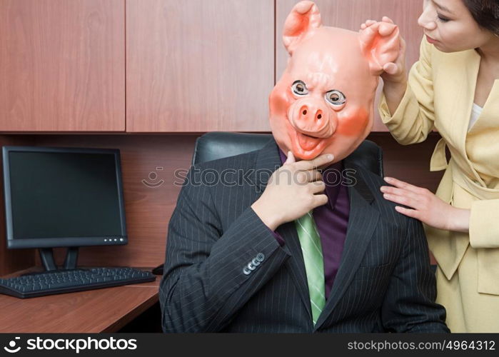 Businessman in pig mask and businesswoman