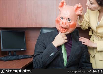 Businessman in pig mask and businesswoman