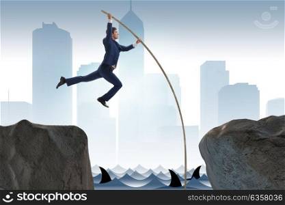 Businessman in pole vaulting concept. The businessman in pole vaulting concept