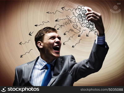 Businessman in rage. Aggressive businessman screaming fiercely in mobile phone