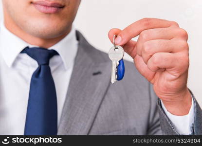 Businessman in real estate concept with home key