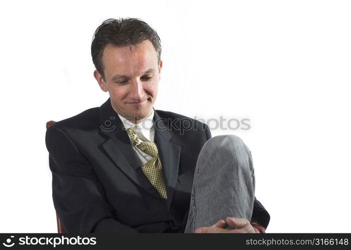 Businessman in relaxed pose smiling and relaxing