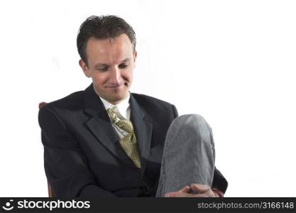 Businessman in relaxed pose smiling and relaxing