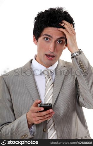 Businessman in shock at his phone