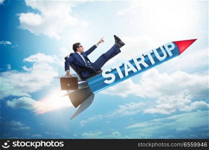 Businessman in start-up concept flying on rocket