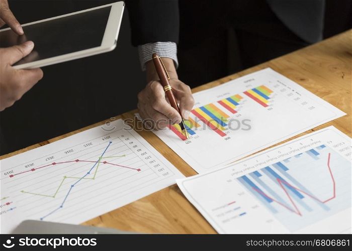 businessman in suit analyze with market analysis business chart document