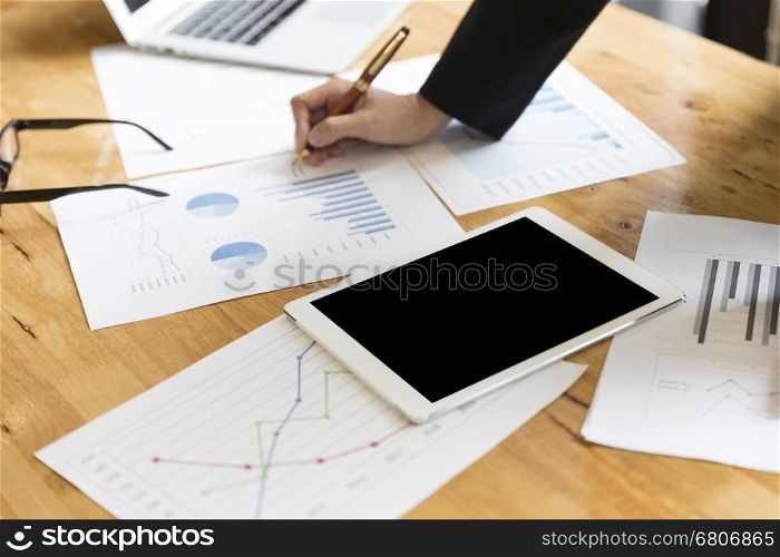 businessman in suit analyze with market analysis business chart document with tablet