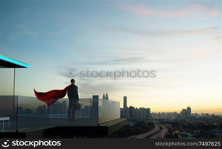 Businessman in suit and cape hero stand at open balcony looking great cityscape view and thinking business plan of the future .
