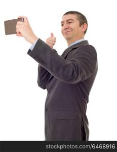 businessman in suit and tie taking selfie photo with mobile phone camera posing happy and successful isolated on white background
