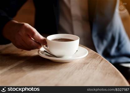 businessman in suit drinking coffee, wealthy successful man holding white cup of coffee or tea sitting by table in cafe, work break of businessman drinking hot drink. businessman in suit drinking coffee, wealthy successful man holding white cup of coffee or tea sitting by table in cafe, work break of businessman drinking hot drink.