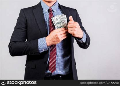 Businessman in suit holding several 100 dollar bills. Finance concept.