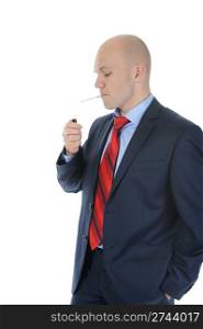 Businessman in suit lights a cigarette. Isolated on white background