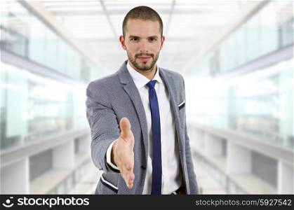 businessman in suit offering to shake the hand at the office