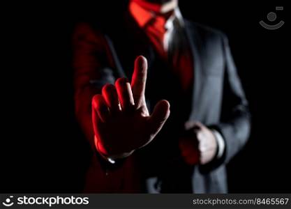 Businessman In Suit Pointing With One Finger On Important Message.. Businessman Pointing With One Finger On Important Message. Executive In Suit Presenting Crutial Information. Gentleman Showing Critical Announcement.