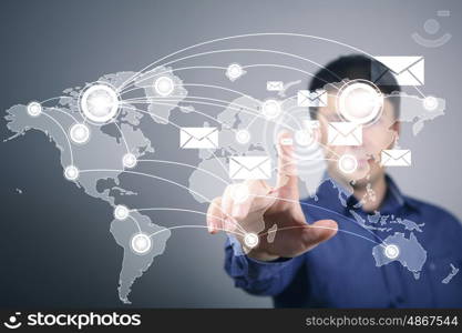 Businessman in suit pressing social media icon