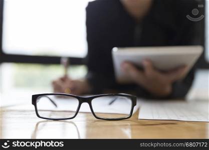 businessman in suit using tablet to analyze market analysis business chart document