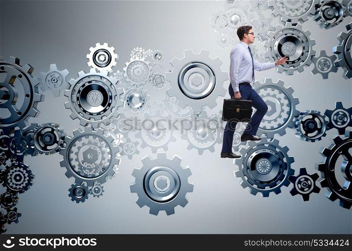 Businessman in teamwork concept with cog wheels
