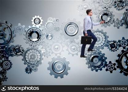 Businessman in teamwork concept with cog wheels