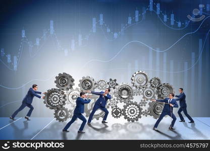 Businessman in teamwork concept with cogwheels