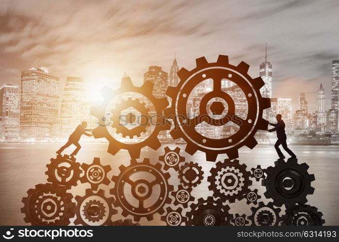 Businessman in teamwork concept with cogwheels