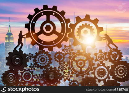 Businessman in teamwork concept with cogwheels