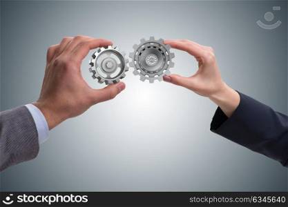 Businessman in teamwork concept with cogwheels