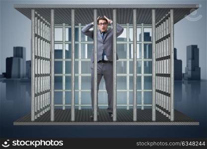 Businessman in the cage business concept