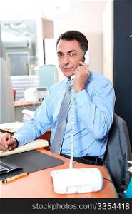 Businessman in the office talking on the phone