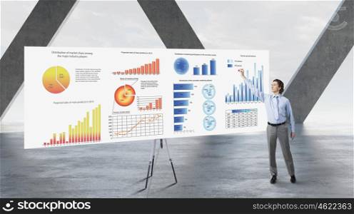 Businessman in top level office. Businessman in building interior and big banner with market data