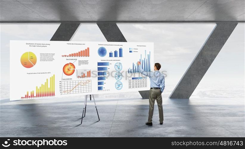Businessman in top level office. Businessman in building interior and big banner with market data