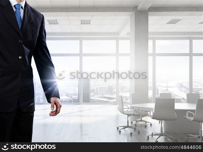 Businessman in top level office. Close view of elegant businessman against modern ofiice window