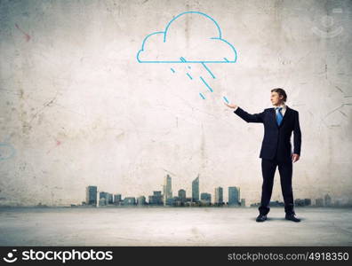 Businessman in trouble. Young businessman catching raindrops with palm. Failure concept