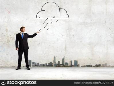 Businessman in trouble. Young businessman catching raindrops with palm. Failure concept